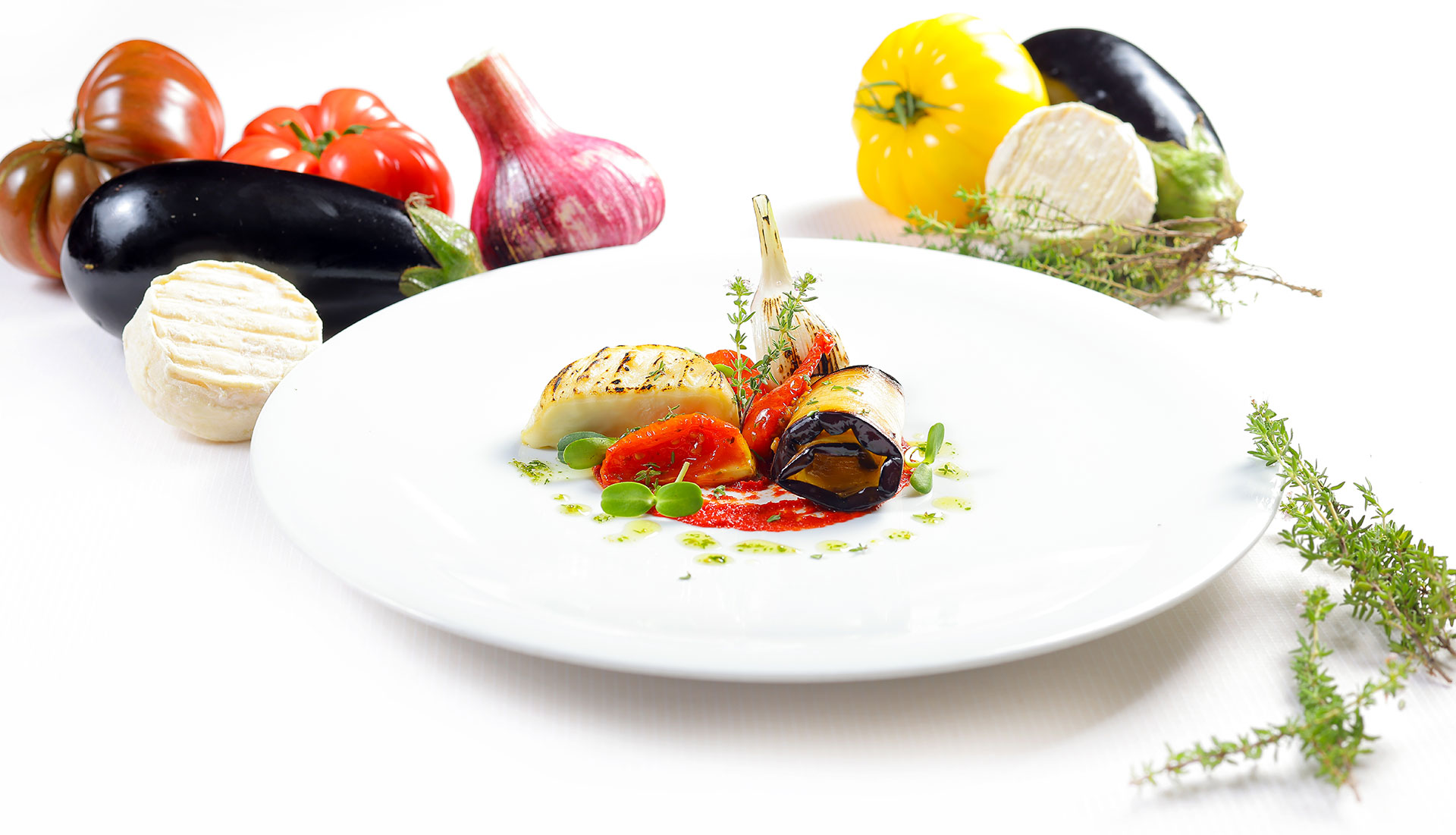 Légumes grillés et fromage de chèvre sur assiette, tomates et aubergines de saison